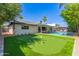 Expansive backyard boasting a pool, putting green, and mature trees for ultimate outdoor enjoyment at 8119 E San Miguel Ave, Scottsdale, AZ 85250