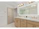 Bright bathroom featuring double sinks, an LED mirror, and a glass-enclosed shower at 8119 E San Miguel Ave, Scottsdale, AZ 85250