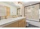 Stylish bathroom with double vanity, granite countertops, and tiled tub and shower at 8119 E San Miguel Ave, Scottsdale, AZ 85250