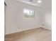 Minimalist bedroom featuring light wood laminate flooring and a window with a view at 8119 E San Miguel Ave, Scottsdale, AZ 85250