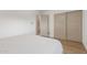Bedroom featuring a closet with sliding doors and neutral wall and trim colors at 8119 E San Miguel Ave, Scottsdale, AZ 85250