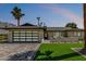 Stunning single-story home with modern curb appeal, turf grass, and contemporary garage door at 8119 E San Miguel Ave, Scottsdale, AZ 85250