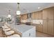 Bright kitchen featuring stainless steel appliances, wood cabinets, and a large island with seating at 8119 E San Miguel Ave, Scottsdale, AZ 85250