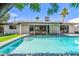 Inviting backyard pool with a tanning ledge, patio area, and seamless indoor-outdoor living at 8119 E San Miguel Ave, Scottsdale, AZ 85250