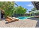 Secluded backyard oasis with a sparkling pool, sun loungers, and beautifully paved patio area at 8119 E San Miguel Ave, Scottsdale, AZ 85250