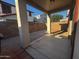 Covered back patio overlooking a fenced backyard with a brick wall and rock landscaping at 876 S Colonial Dr, Gilbert, AZ 85296