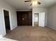 Bedroom with carpet floors, ceiling fan, and storage shelves at 876 S Colonial Dr, Gilbert, AZ 85296