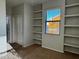 Bedroom featuring carpet floors, natural lighting, shelves, and closet at 876 S Colonial Dr, Gilbert, AZ 85296