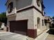 Exterior view of a townhouse with a private garage and well kept landscape at 876 S Colonial Dr, Gilbert, AZ 85296