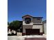 Exterior view of a two-story townhouse with a private garage and neatly kept landscape at 876 S Colonial Dr, Gilbert, AZ 85296