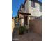 Townhouse exterior featuring stucco, an arched entry, and a privacy wall at 876 S Colonial Dr, Gilbert, AZ 85296