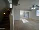 Bright living room featuring stairs, tile floors, and a ceiling fan at 876 S Colonial Dr, Gilbert, AZ 85296