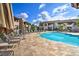 Relaxing community pool with ample lounge seating and umbrellas amid a lush green landscape at 9450 E Becker Ln # 2067, Scottsdale, AZ 85260