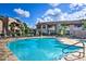 Serene community pool featuring multiple lounge chairs and pristine landscaping, perfect for relaxation at 9450 E Becker Ln # 2067, Scottsdale, AZ 85260