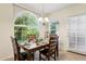Bright dining area with a wooden table set for a meal, large windows offering plenty of natural light at 9450 E Becker Ln # 2067, Scottsdale, AZ 85260