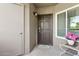 A charming front door with a 'hello summer' doormat and decorative flowers welcomes you at 9450 E Becker Ln # 2067, Scottsdale, AZ 85260