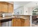 Functional kitchen area featuring wood cabinetry, granite counters, and a stainless steel dishwasher at 9450 E Becker Ln # 2067, Scottsdale, AZ 85260