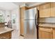 An efficient kitchen space with a stainless steel refrigerator and light wood cabinets at 9450 E Becker Ln # 2067, Scottsdale, AZ 85260