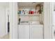 Well-organized laundry closet equipped with washer, dryer, and shelving, maximizing space and efficiency at 9450 E Becker Ln # 2067, Scottsdale, AZ 85260