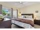 Bright main bedroom with a ceiling fan, comfy bed, and balcony access, creating a relaxing retreat at 9450 E Becker Ln # 2067, Scottsdale, AZ 85260