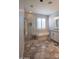 Beautiful bathroom with a glass-enclosed shower, tub, and stylish hexagonal floor tiles at 10655 N 9Th St # 112, Phoenix, AZ 85020