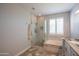 Updated bathroom with a glass-enclosed shower, soaking tub, marble-look tile, and hexagon tile floors at 10655 N 9Th St # 112, Phoenix, AZ 85020