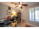 Bedroom featuring a ceiling fan, work desk, and dark wood shelving at 10655 N 9Th St # 112, Phoenix, AZ 85020