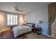 Inviting bedroom with wood floors, ceiling fan and a plush bed with decorative pillows at 10655 N 9Th St # 112, Phoenix, AZ 85020