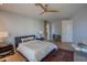 Inviting bedroom with wood floors, ceiling fan and a plush bed with decorative pillows at 10655 N 9Th St # 112, Phoenix, AZ 85020