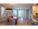 Bright dining room featuring light wood floors, modern chandelier, and floor to ceiling windows at 10655 N 9Th St # 112, Phoenix, AZ 85020