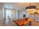 Bright dining room featuring light wood floors, modern chandelier, and floor to ceiling windows at 10655 N 9Th St # 112, Phoenix, AZ 85020