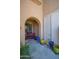 Inviting front porch with arched entry, colorful potted plants, and a red bench at 10655 N 9Th St # 112, Phoenix, AZ 85020