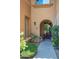 Inviting front porch with arched entry, colorful potted plants, and a red bench at 10655 N 9Th St # 112, Phoenix, AZ 85020