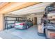 The garage features a sports car, epoxy flooring, and ample storage shelves at 10655 N 9Th St # 112, Phoenix, AZ 85020