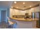 Lovely kitchen with stainless steel appliances, white cabinets, granite countertops, and a breakfast bar at 10655 N 9Th St # 112, Phoenix, AZ 85020