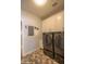Laundry room with full-size washer and dryer and white cabinets at 10655 N 9Th St # 112, Phoenix, AZ 85020
