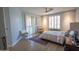 Bright main bedroom with white shutters, neutral walls, wood-look floors, and a ceiling fan at 10655 N 9Th St # 112, Phoenix, AZ 85020