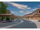 Scenic community street view displaying beautiful townhomes with desert landscaping under a bright sky at 10655 N 9Th St # 112, Phoenix, AZ 85020