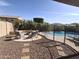Cozy backyard with pebble landscaping, pool, and outdoor seating at 10773 W Prickly Pear Trl, Peoria, AZ 85383