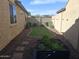 Well-kept backyard with a small lawn and garden beds at 10773 W Prickly Pear Trl, Peoria, AZ 85383