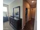 Bedroom with a view into the closet, beautiful hardwood floors, and large mirror at 10773 W Prickly Pear Trl, Peoria, AZ 85383