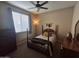 Cozy bedroom with a four-poster bed and ample natural light at 10773 W Prickly Pear Trl, Peoria, AZ 85383