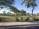 Scenic community park featuring lush green space, mature trees, playground equipment, and walking paths at 10773 W Prickly Pear Trl, Peoria, AZ 85383