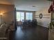 Spacious dining room features hardwood floors, large windows, and a decorative wall piece at 10773 W Prickly Pear Trl, Peoria, AZ 85383