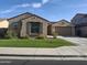 Charming single-story home with a well-maintained front yard and an attached two-car garage at 10773 W Prickly Pear Trl, Peoria, AZ 85383