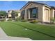 Landscaped front yard featuring lush green turf, flowering bushes and a cozy, inviting facade at 10773 W Prickly Pear Trl, Peoria, AZ 85383