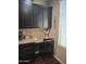 Kitchen features an adjacent desk area with granite counters and dark cabinets at 10773 W Prickly Pear Trl, Peoria, AZ 85383