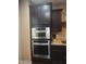 This kitchen boasts stainless steel appliances with dark wood cabinetry at 10773 W Prickly Pear Trl, Peoria, AZ 85383