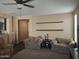Comfortable living room with neutral colors and modern ceiling fan at 10773 W Prickly Pear Trl, Peoria, AZ 85383