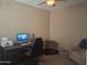 Home office space with a desk, computer, and comfortable seating area at 10773 W Prickly Pear Trl, Peoria, AZ 85383